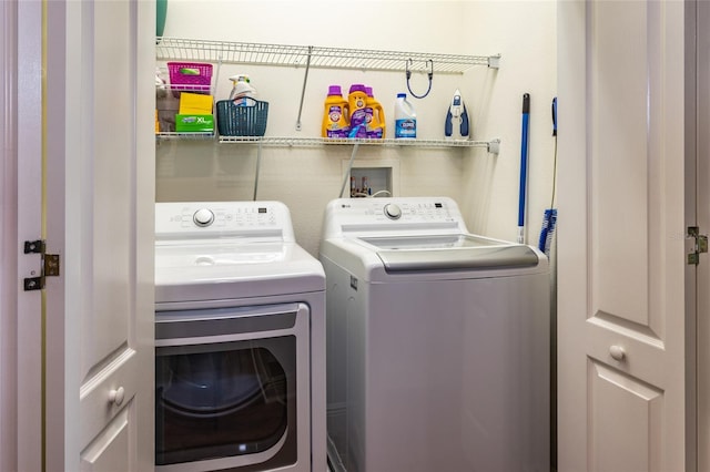 washroom featuring laundry area and washing machine and clothes dryer