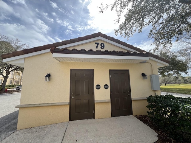 view of front of house with a tiled roof and stucco siding