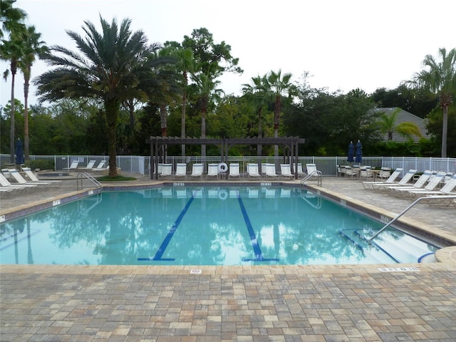 community pool with fence, a patio, and a pergola