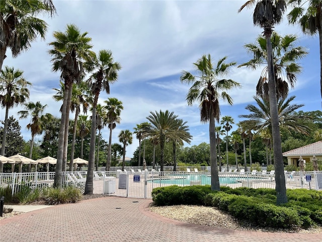 view of home's community with fence and a swimming pool