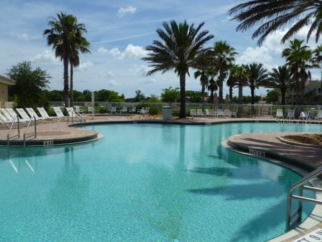 pool with fence and a patio