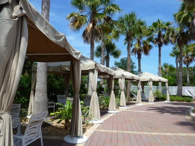 view of community with fence, a patio, and a gazebo