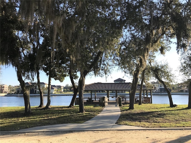 view of home's community featuring a water view and a lawn