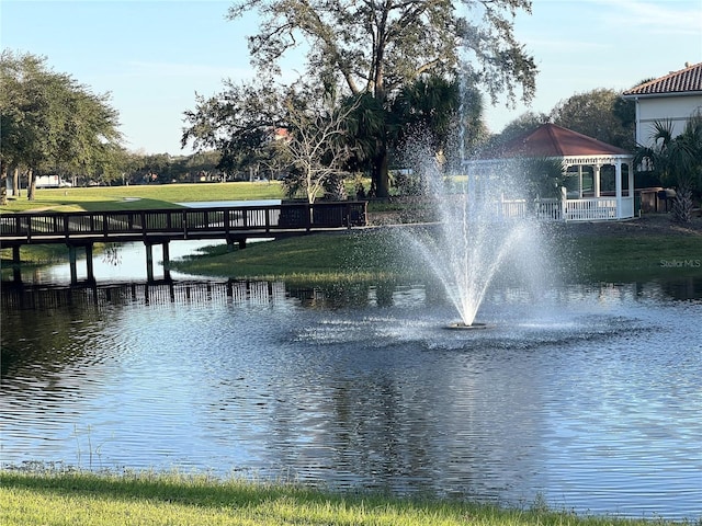 view of property's community with a water view and a gazebo