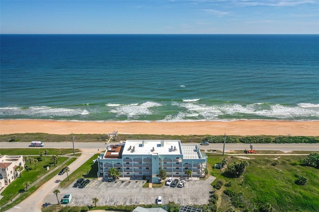 aerial view with a water view and a view of the beach