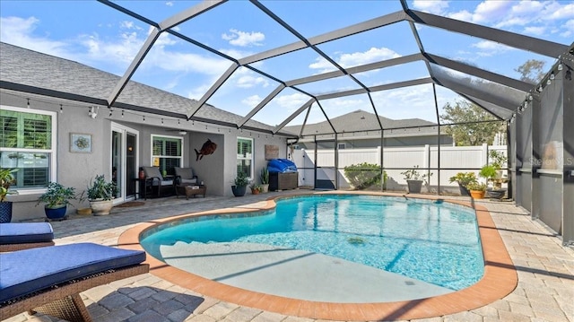 view of pool featuring a fenced in pool, glass enclosure, a patio, and fence