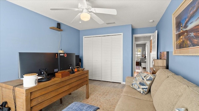 office area featuring visible vents, wood finished floors, and a ceiling fan