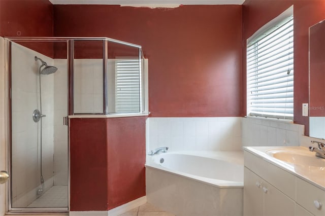 bathroom with a stall shower, tile patterned flooring, vanity, and a bath