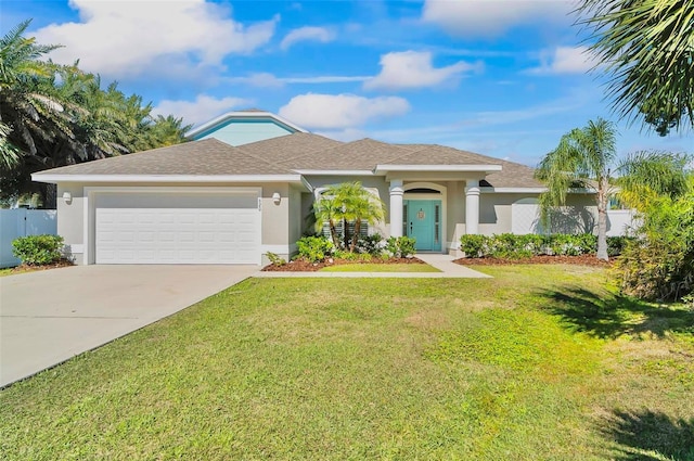 single story home with a garage, concrete driveway, a front lawn, and stucco siding