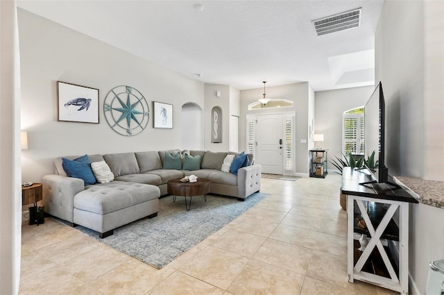 living room featuring light tile patterned floors and visible vents