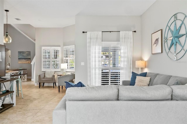 living area with light tile patterned floors and visible vents