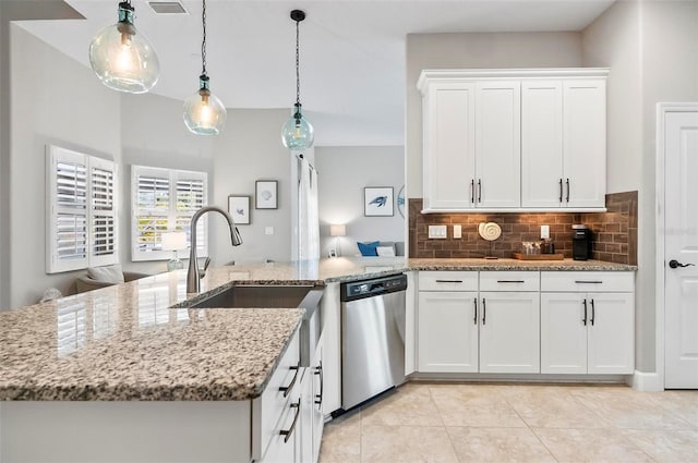 kitchen with tasteful backsplash, dishwasher, pendant lighting, light stone counters, and white cabinets