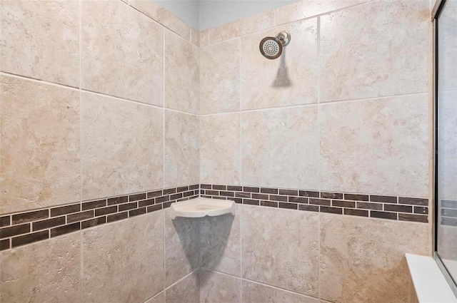 interior details with a tile shower