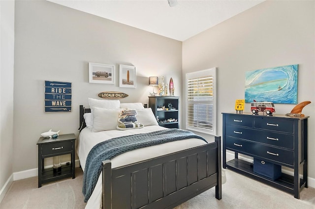 bedroom with light carpet and baseboards