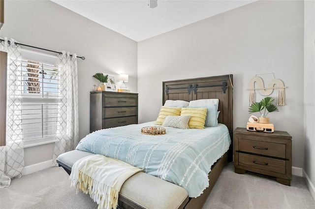 bedroom with ceiling fan, baseboards, and carpet