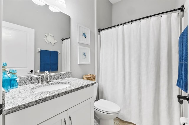 bathroom with toilet and vanity