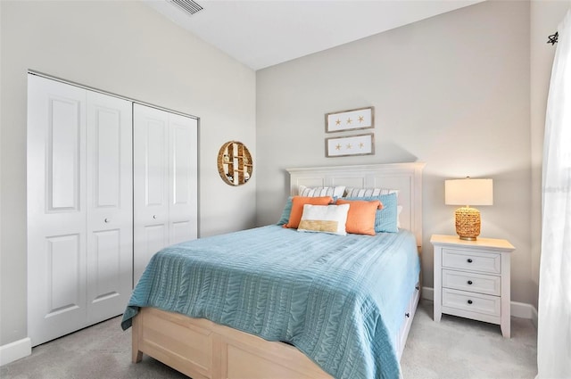 bedroom with visible vents, baseboards, light colored carpet, and a closet