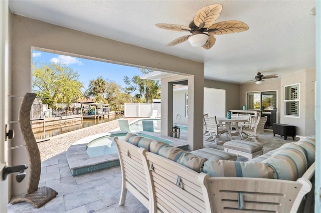 view of patio with a fenced in pool, outdoor dining area, ceiling fan, and fence