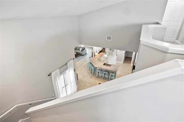 staircase with tile patterned floors and visible vents