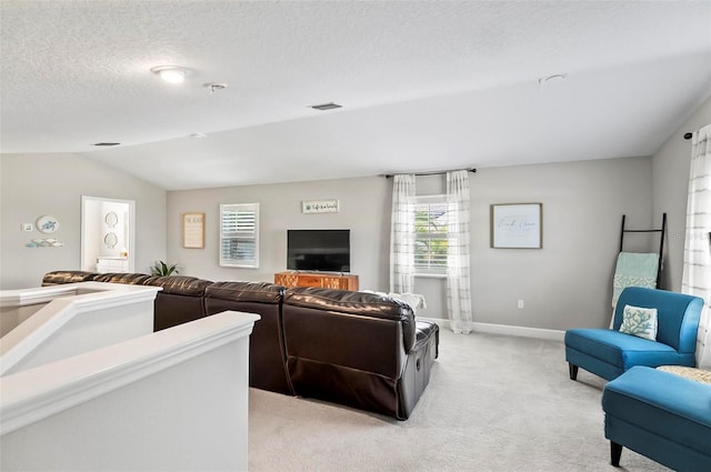 living room with baseboards, visible vents, vaulted ceiling, a textured ceiling, and light carpet