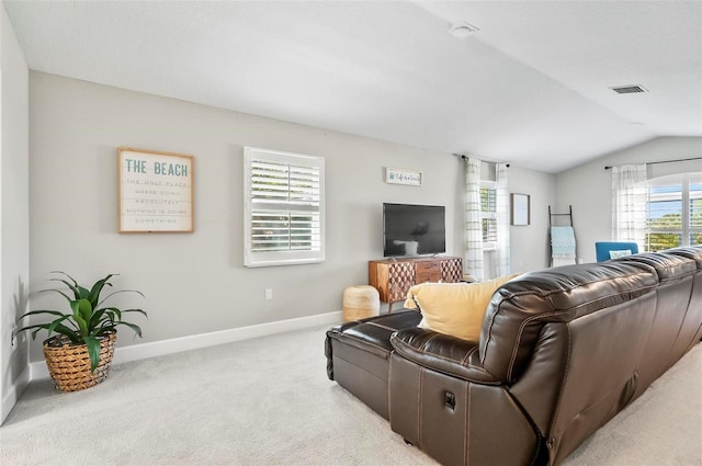 living room featuring visible vents, baseboards, lofted ceiling, and carpet floors