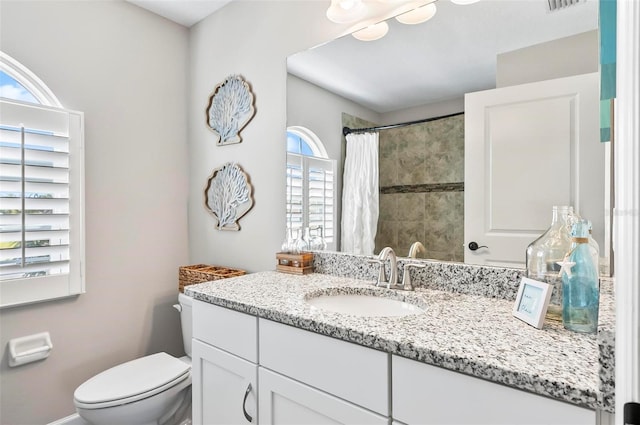 full bath with visible vents, toilet, vanity, and a shower with curtain