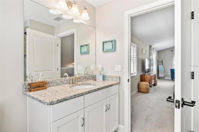 bathroom with vanity, baseboards, and visible vents