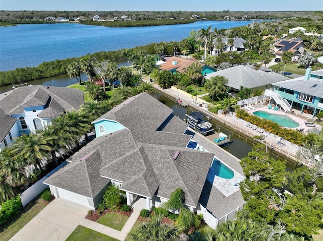 drone / aerial view featuring a water view and a residential view