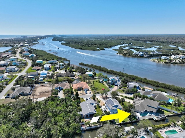 birds eye view of property featuring a water view and a residential view