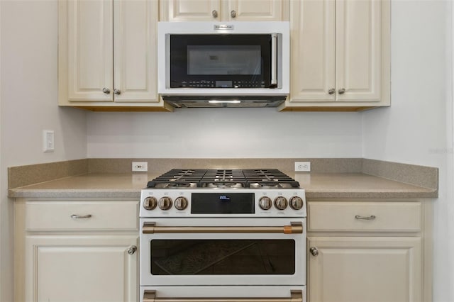 kitchen with high end white range oven and light countertops