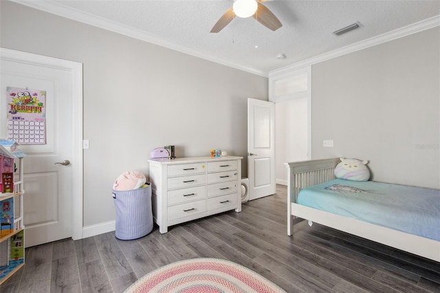 bedroom featuring visible vents, wood finished floors, a ceiling fan, and ornamental molding