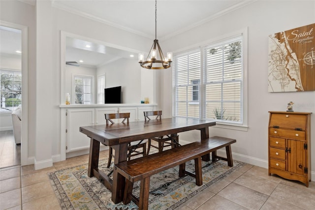 dining room with light tile patterned floors, plenty of natural light, and ornamental molding