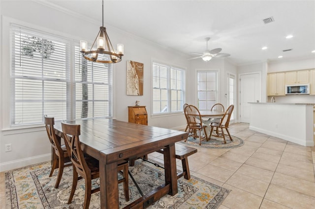 dining space with visible vents, baseboards, light tile patterned flooring, and ornamental molding