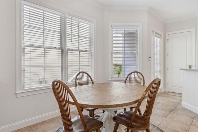 dining space with light tile patterned floors, baseboards, and ornamental molding