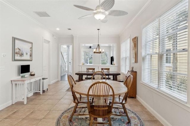 dining room with light tile patterned floors, baseboards, visible vents, crown molding, and ceiling fan with notable chandelier