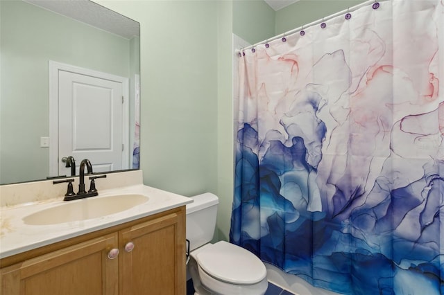 bathroom featuring toilet, curtained shower, and vanity