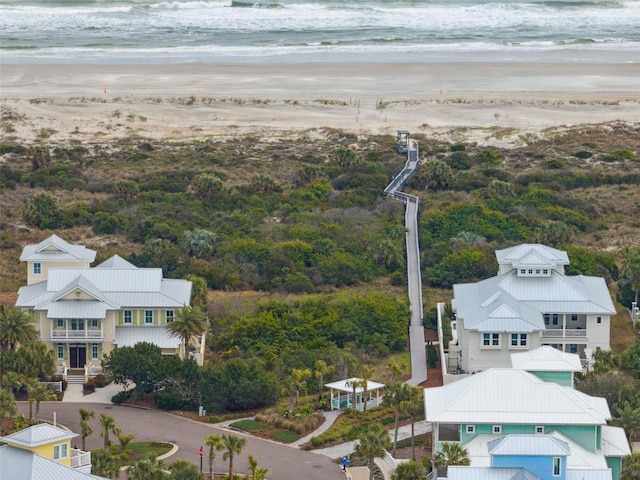 bird's eye view featuring a water view and a beach view