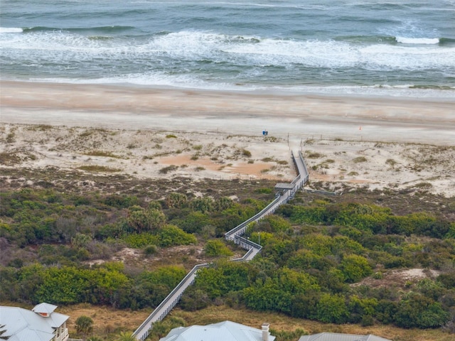 birds eye view of property with a beach view and a water view