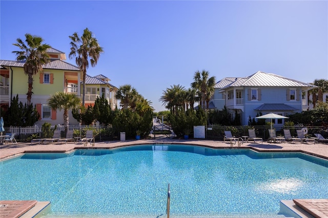 community pool featuring a patio and fence