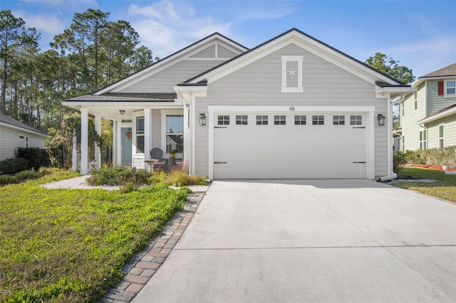 view of front of house featuring an attached garage, a porch, and concrete driveway