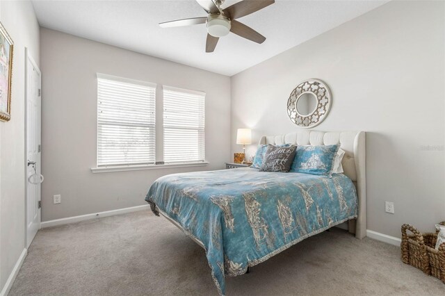 bedroom with carpet flooring, a ceiling fan, and baseboards