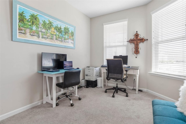 carpeted home office with baseboards