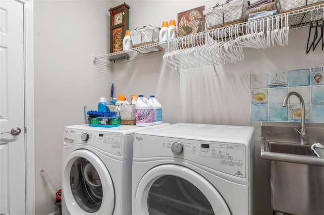 laundry area featuring laundry area, a sink, and separate washer and dryer