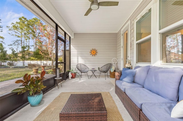 sunroom / solarium featuring ceiling fan