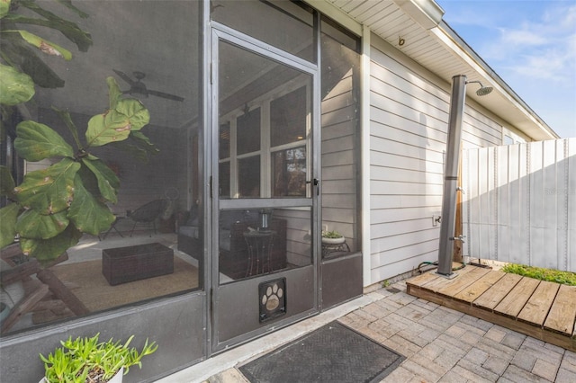 property entrance with a patio area and fence