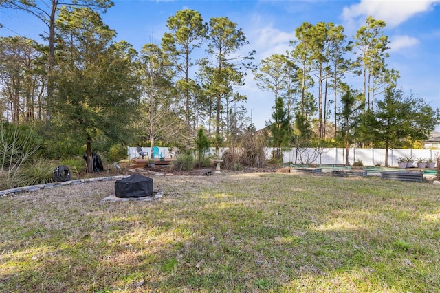 view of yard with a garden, fence, and a deck