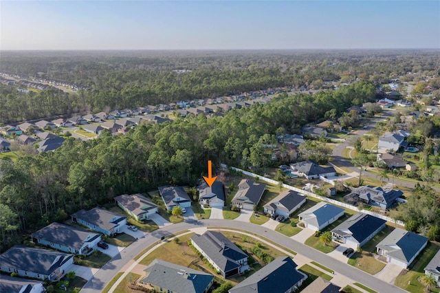 aerial view featuring a wooded view and a residential view