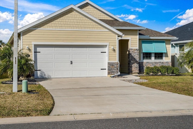 view of front of property featuring stone siding, an attached garage, concrete driveway, and roof with shingles