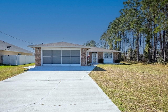 ranch-style home featuring brick siding, a garage, driveway, and a front lawn