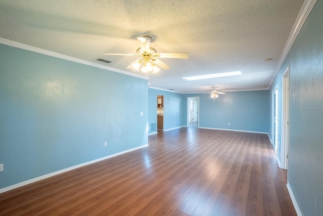 spare room with visible vents, ornamental molding, a ceiling fan, a textured ceiling, and dark wood-style floors